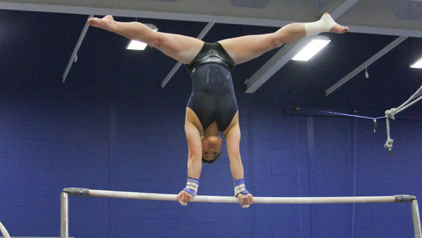 Senior gymnast balancing rare injury and competitiveness