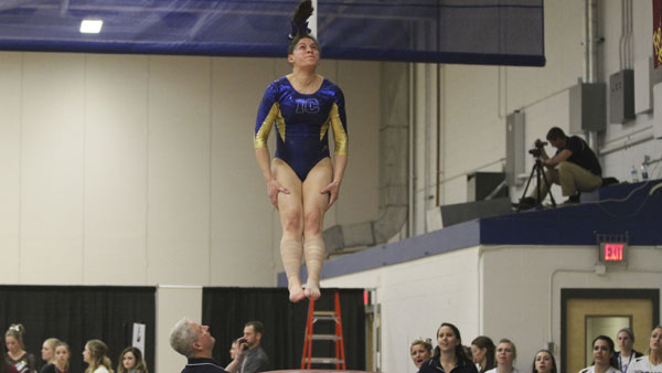 Freshman all-around gymnast Alexis Mena soars through the air as she competes in the vault event at the National Collegiate Gymnastics Association Championships on March 21 in Ben Light Gymnasium.