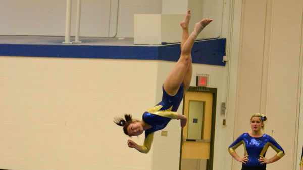 Sophomore all-around competitor Meghan Harrington flips through the air during her floor exercise routine at the gymnastics team’s meet against SUNY Cortland on March 1 in Ben Light Gymnasium.
