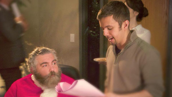 Junior Erich Westfield gives notes to Theodore Bouloukos, who plays Santa Claus, during the filming of Rudolph vs. Reese, written by sophomore Mitchell Ward, who won the David Ames Film Award for his movie script.