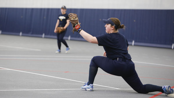 Senior infielder Sydney Folk catches the ball in her mitt during the softball team’s practice March 26 at Glazer Arena. Folk has recorded at least one hit in nine of 10 games played. The Bombers are 8–2 to begin the season.