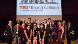Senior Michela Moe, senior Ilana Miller and sophomore Lulu Helliwell stand with 14 speakers who shared TED-style talks at TEDxIthaca College on March 22 in the Hockett Family Recital Hall. Courtesy of Eric Yeckley
