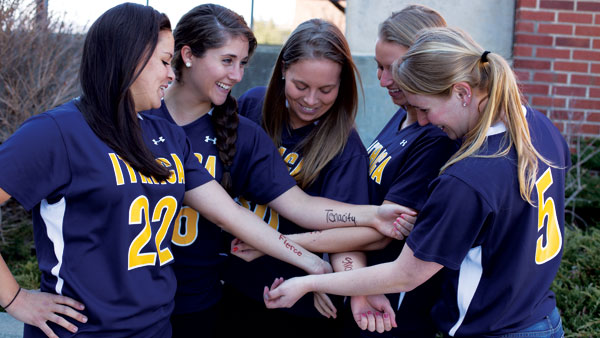 Seniors of the womens lacrosse team show off their pregame arm marks April 2.