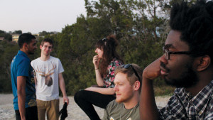 Freshman San Williams and his band relax on the beach during the South by Southwest music festival, where they played two sets. Williams is a rapper who utilizes non-traditional hip-hop instruments like cello in his music. COURTESY OF JESSE ROLFE
