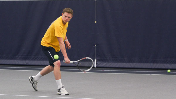 Senior Griffin Reid hits a backhand shot during the men’s tennis team’s practice April 22 in Glazer Arena. Reid has a 5–1 record against Empire 8 conference opponents this season.