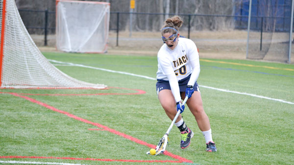 Junior attack Emily Peters scoops up the loose ball during the women’s lacrosse team’s win against William Smith College on April 8 at Higgins Stadium. Peters has seven goals this year.