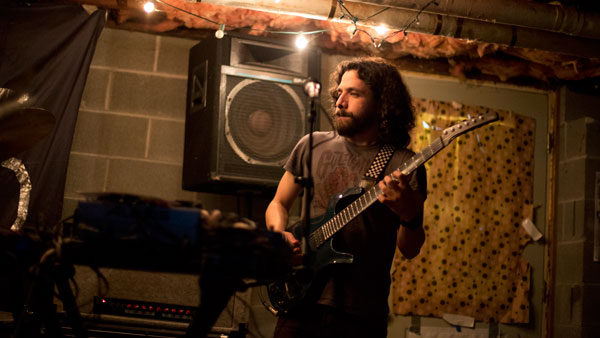 Bubba Crumrine, head of the Ithaca Underground, plays guitar at an Ithaca Underground concert.