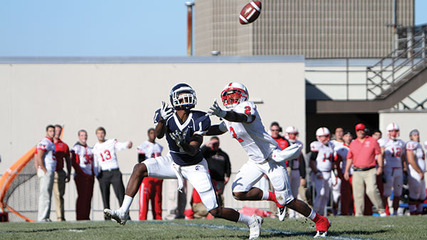 From left, senior wide receiver Joel Lynch positions himself to catch the ball with SUNY Cortland junior cornerback Ke’shaun Stallworth covering him during Cortaca on Nov. 16, 2013, at Butterfield Stadium. 