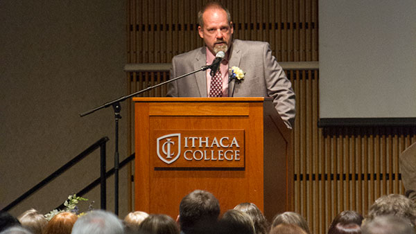 Michael Buck, clinical associate professor of physical therapy and Master of Ceremony, addresses the sixth year physical therapy graduates at the closing ceremony Aug. 17 in Emerson Suites.