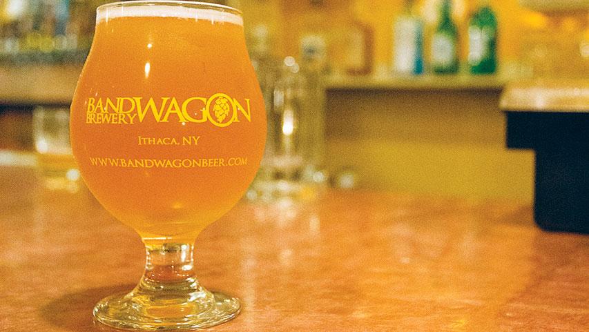 A glass of beer sits on the bar at Bandwagon Brewpub in downtown Ithaca. Bandwagon is one of the many breweries in Central New York which have preserved traditional brewing practices.