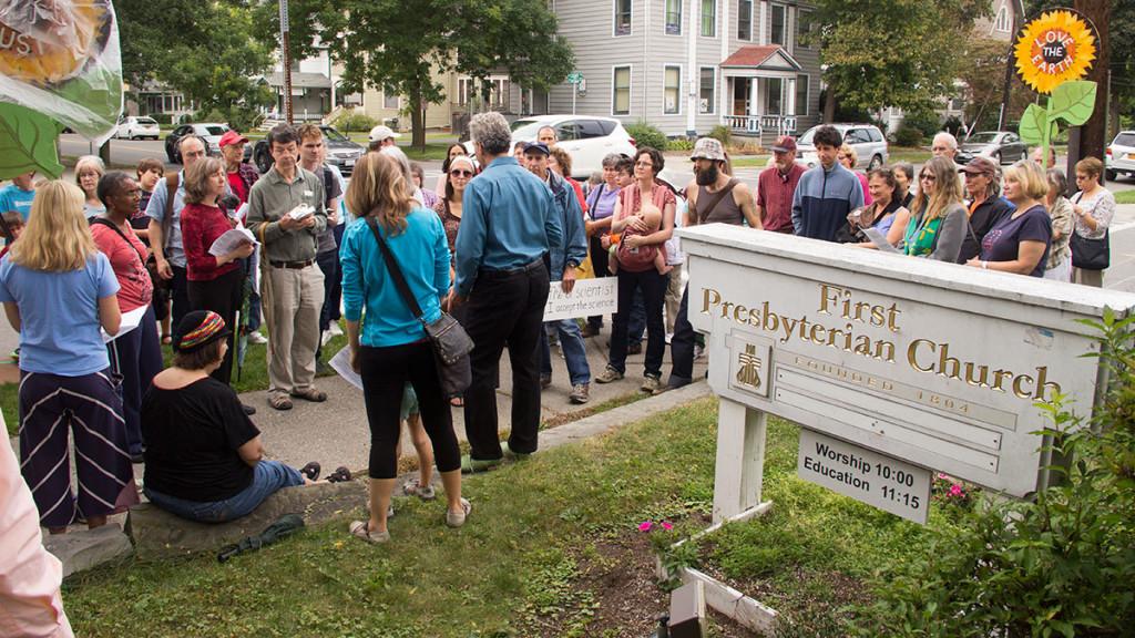 Ithaca locals gather outside the Presbyterian Church, located on the corner of Cayuga and Court streets, before walking for the Ithaca Area Peoples Climate March, which was held Sept. 21.