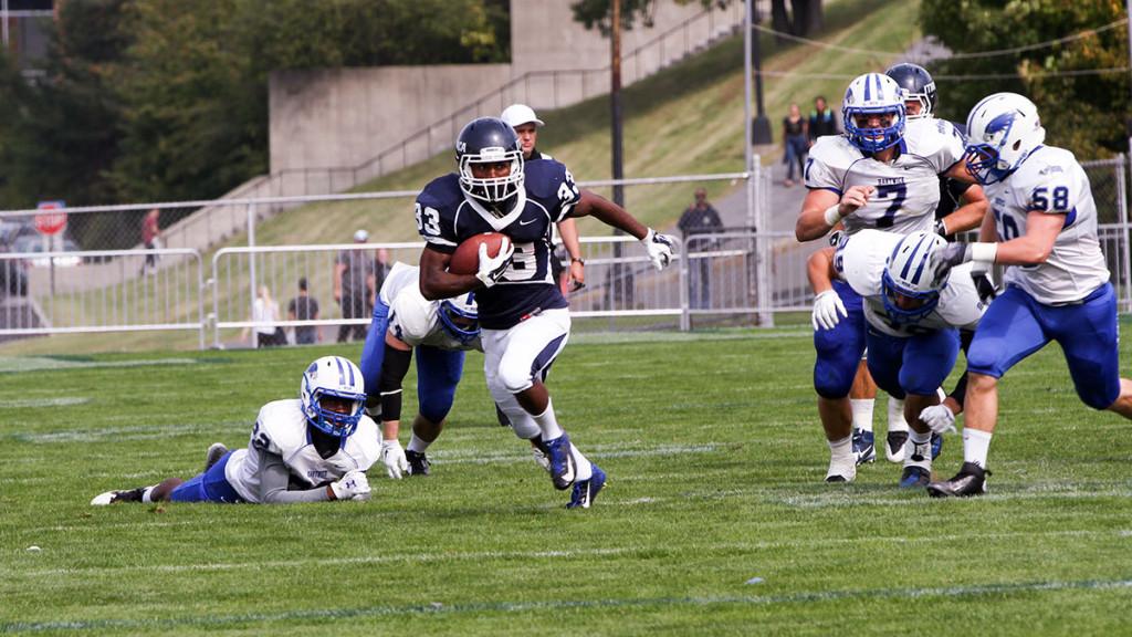 Freshman running back Tristan Brown runs through the Hartwick College defense during the Bombers 42–7 win over the Hawks Sept. 20 at Butterfield Stadium. 