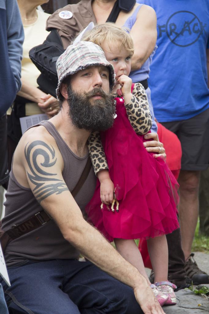 Nicholas Gecan kneels beside his daughter, Audrey Gecan, during the Peoples Climate March in Ithaca on Sept. 21.