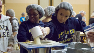From left: Sophomores Michelle Lee and Jamie Shum pour pre-measured portions of vitamins and vegetables at the Feed My Starving Children Mobile Pack event at the Church of Jesus Christ of Latter-day Saints Sept. 13. Sabrina Knight/The Ithacan