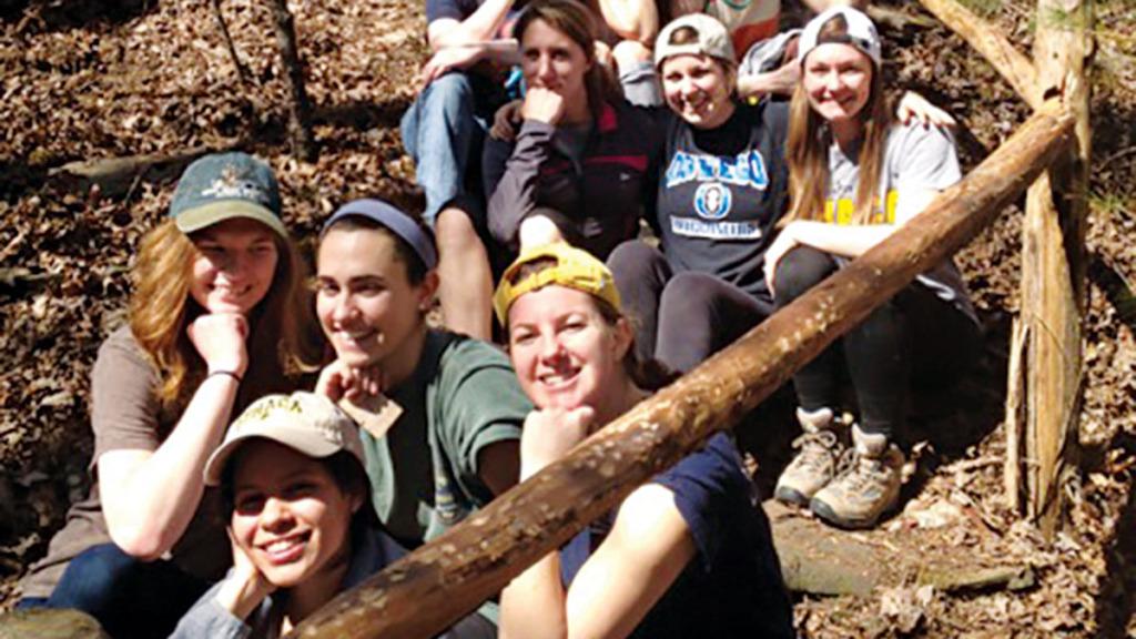 ​Ithaca College students sit by their completed railing system for a nature trail at Historic Ruby, Tennessee, at the 2014 Alternative Spring Break trip. 