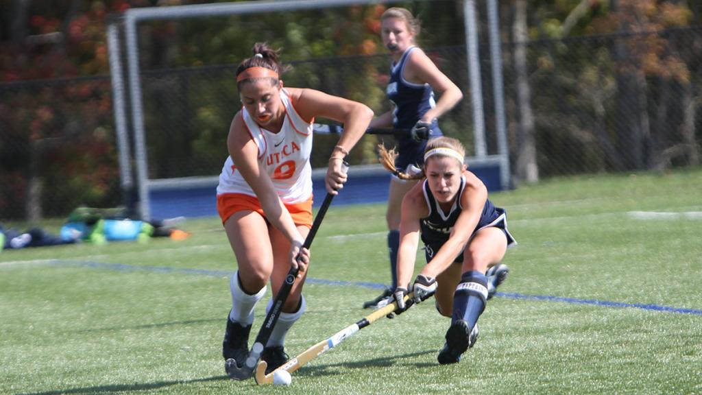 From right, senior midfielder Natalie Lynch fights for possession with Utica College senior Alaina Stojkovski during the field hockey team’s 3–2 loss to the Pioneers. Lynch has two goals this season