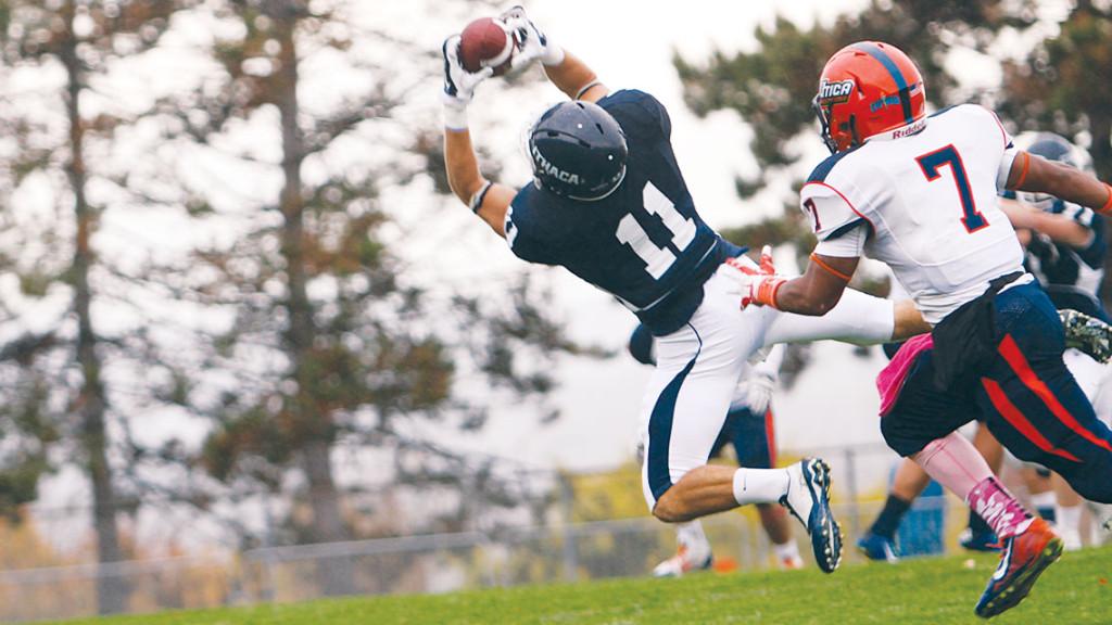 From left, senior wide receiver Chris Bauer makes a reception while Utica College senior cornerback Rob Alexander covers him in the Bombers’ 27–10 win over Utica on Oct. 4 at Butterfield Stadium. 