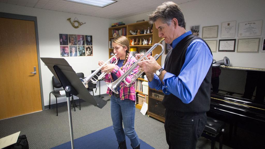 From left, junior Kaitlyn DeHority, principal trumpet of the Ithaca College Orchestra, and Frank Gabriel Campos, professor of trumpet performance, practice in his office on Oct. 21. 