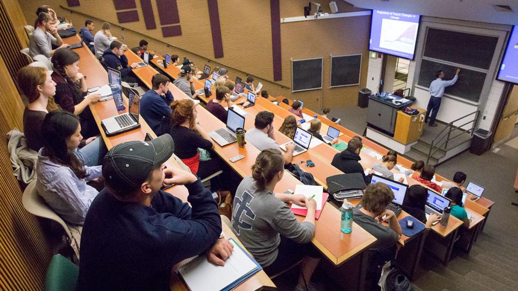 Students take notes on their laptops and by hand as John Hopple, a lecturer for the  Department of Biology, teaches his Environmental Biology course in Williams 323. 