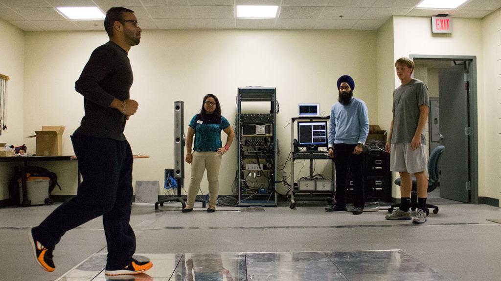 From left, senior Julian Rivera performs a running balance test on Oct. 21 in the Center for Health Sciences room 102, as senior Paulina Codera, physical therapy professor Rumit Singh Kakar and senior Ryan Norland observe.