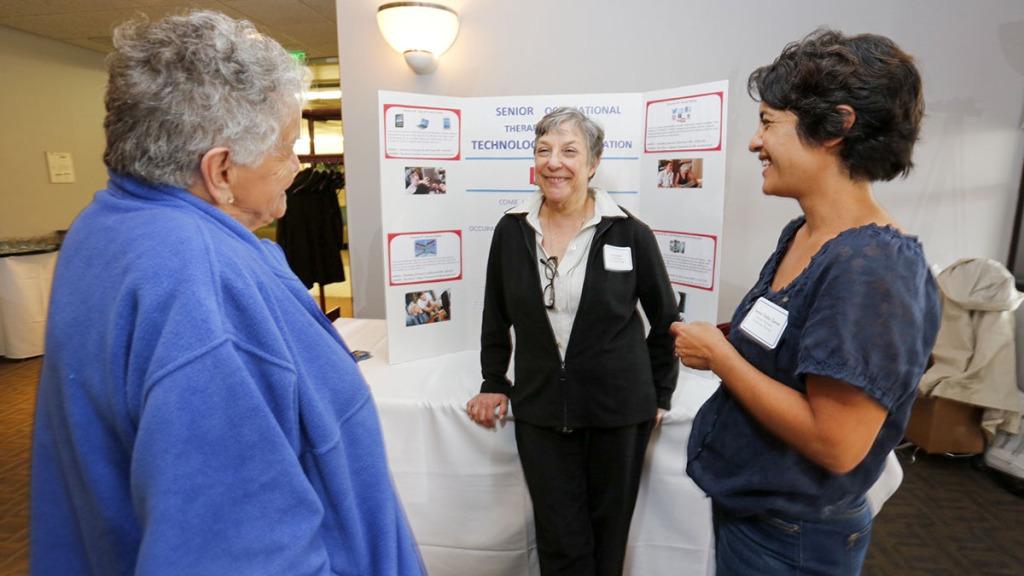 From left: Longview resident Ardie Bennett speaks with Lynn Gitlow and Jessica Taves, both faculty members in occupational therapy at Ithaca College, at the IC/Longview partnership celebration on Oct. 29 in Clark Lounge.