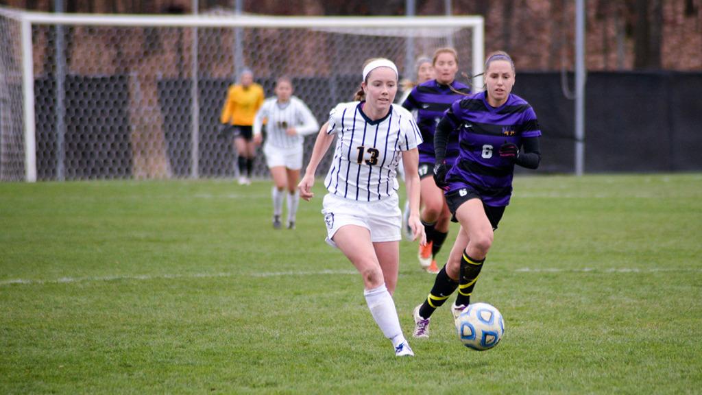 From left, junior forward Sarah Woychick takes the ball downfield in the Empire 8 championship game against Nazareth College on Nov. 7 at Carp Wood Field. The South Hill squad tied the Golden Flyers but were outshot 4–3 in penalty kicks, earning a share of the E8 title.
