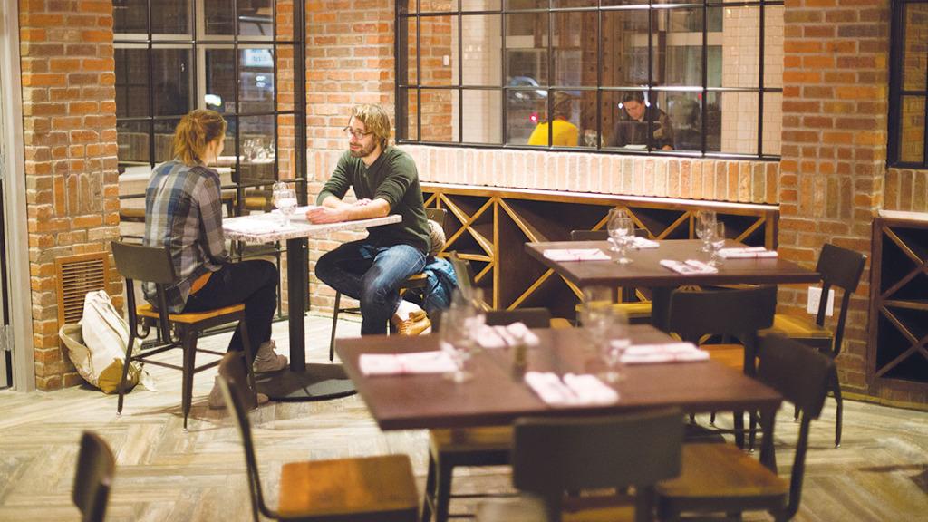 From left, Daphne Fesheyer and Mathias Ellegieris sit at a table Dec. 5 during a soft opening at Coltivare. The restuarant officially opens to the public Dec. 13. 