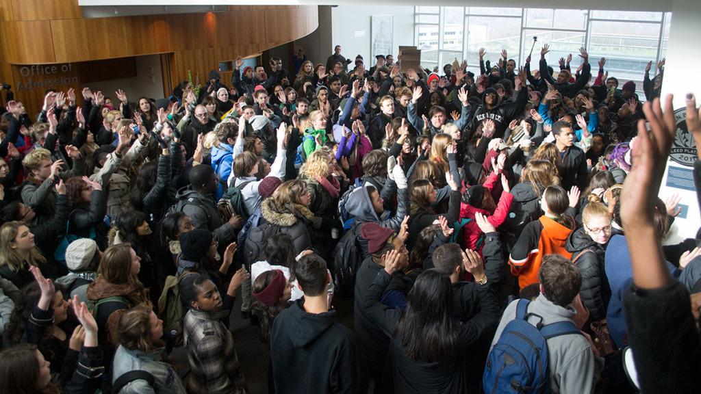 Over 300 students at Ithaca College raise their hands on Dec. 4 in Peggy Ryan Williams to protest in response to the death of Eric Garner, who died by chokehold on July 17.  Jennifer Williams/The Ithacan