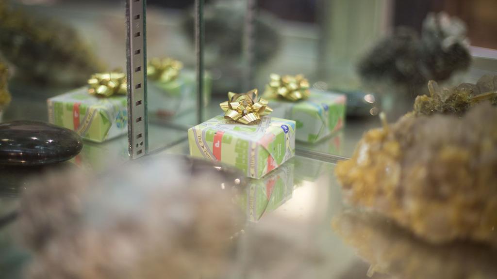 A present is hidden in a display case in Multifaceted Minerals, one of many stores participating in Presents on the Commons, a small-business scavenger hunt. Stores reward those who find the gifts in Ithacash, a new local currency.