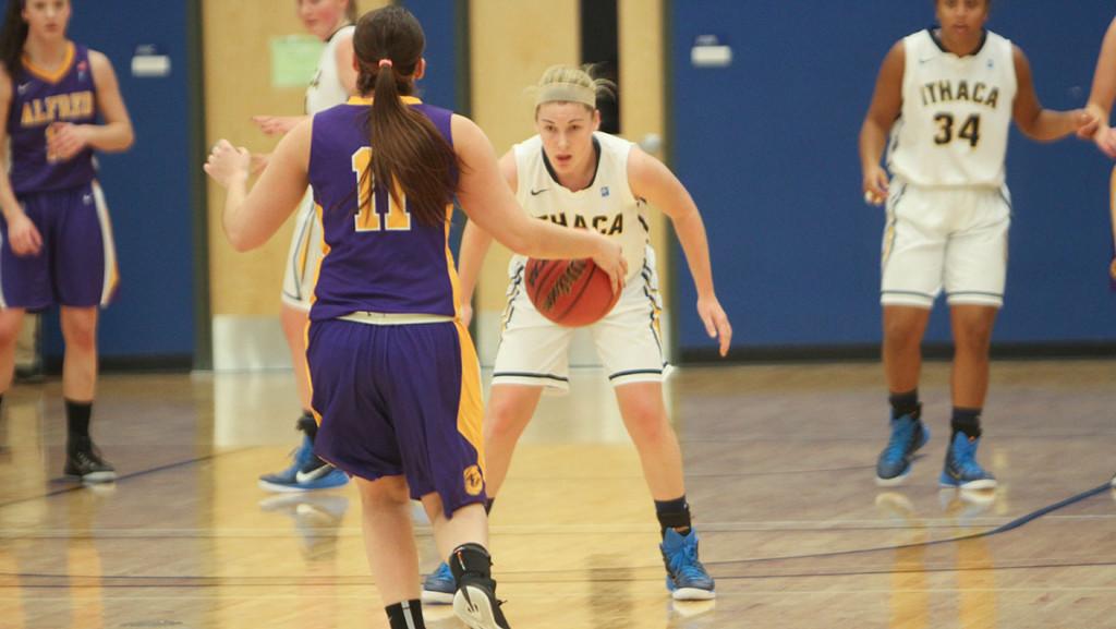 Freshman guard Jordan Beers defends the Alfred University point guard during the teams 82–43 rout of the Saxons.