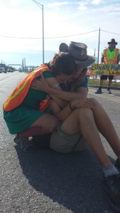 Marchers Sean Glenn and Kelsey Erickson share an emotional moment as they block the roadway at the Whiting oil refinery.