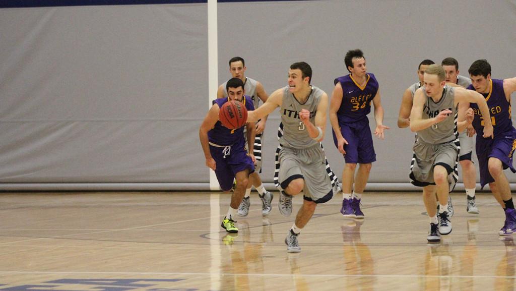 Freshman Marc Chasin takes the ball up the court in the team’s game Jan. 23 against Alfred University.	