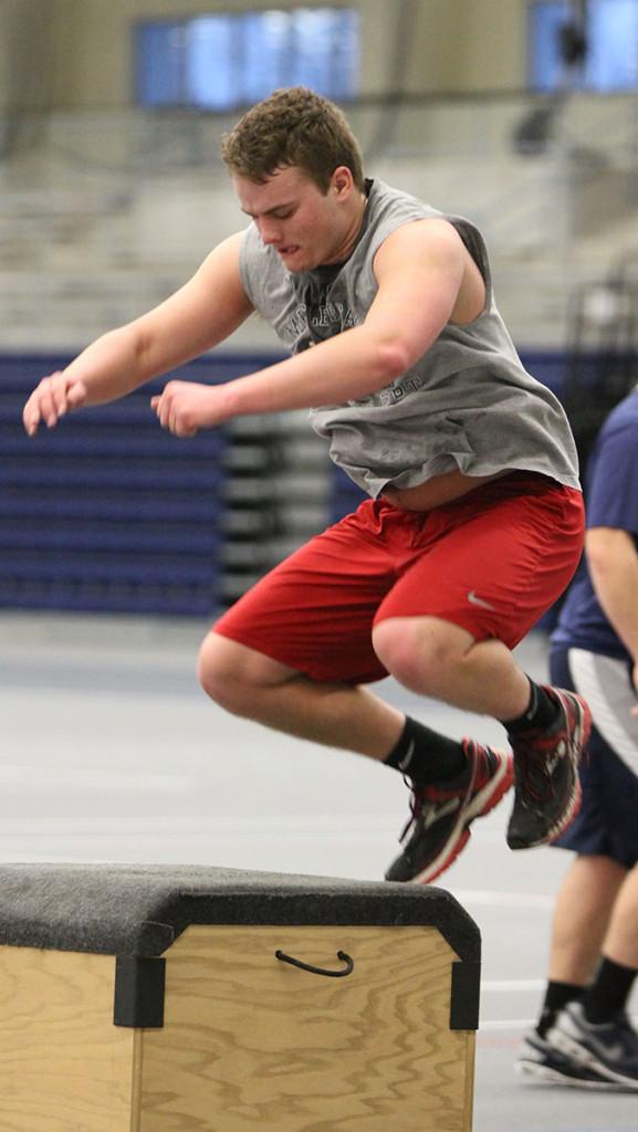 Freshman Austin Barrett, who played junior varsity last year, performs a box jump during football practice Feb. 12. Amanda den Hartog/The Ithacan