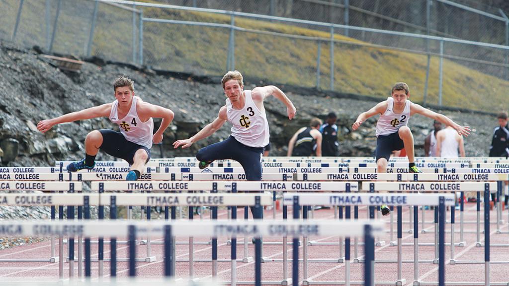 From left, sophomore Sam Piraneo, junior Dane Eckweiler and sophomore Tyler Denn-Thiele compete in the 400-meter hurdles at the Ithaca Tuesday Meet on April 22, 2014, at Butterfield Stadium. Eckweiler finished first.