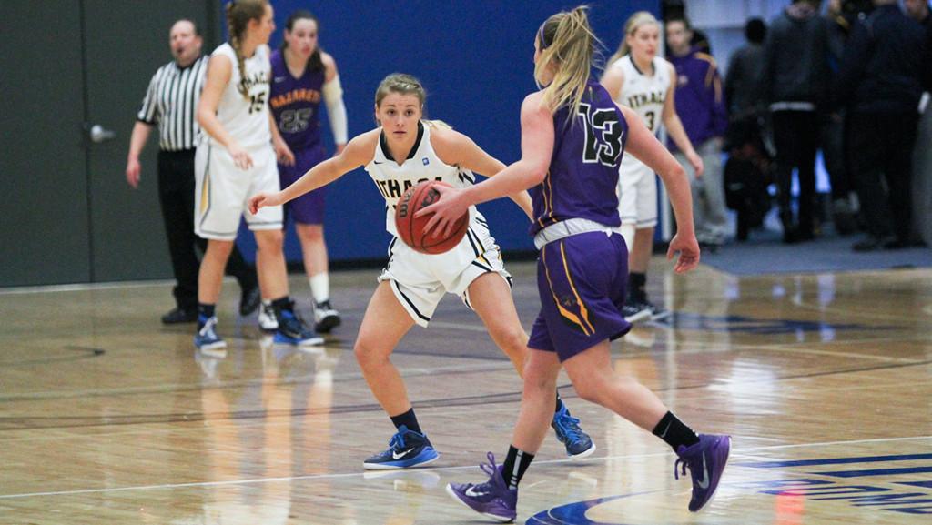 Freshman guard Erin Woop defends her opponent in the women’s basketball team’s 70–60 victory over Nazareth College Jan. 31. The Bombers own a 16–4 record on the season.