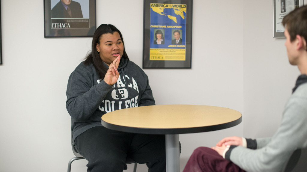 Sophomore Cherokee Charles speaks to junior emerging media major Rob Mayo using ASL. Charles is a deaf studies minor.