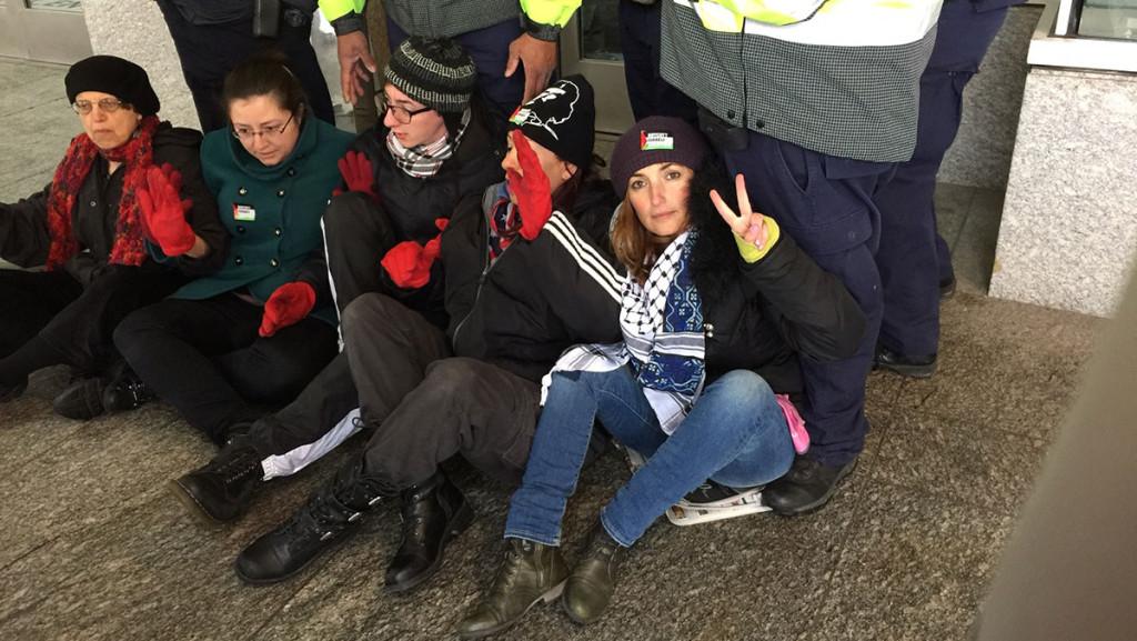 Five protesters were arrested for attempting to block the entrance to the American Israel Public Affairs Committee Policy Conference, including former Ithaca College professor Beth Harris, far left , and Ithaca resident Ariel Gold, far right.  