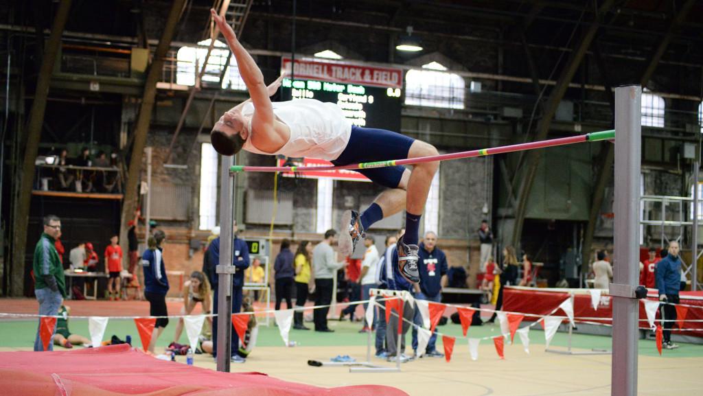 Junior Andrew Brandt leaps over the high jump bar in the Cornell Relays on Dec. 6 at Barton Hall. Brandt quit the men’s basketball team after his sophomore year to join the men’s track and field team. He has jumped a career-best 2.03 meters.