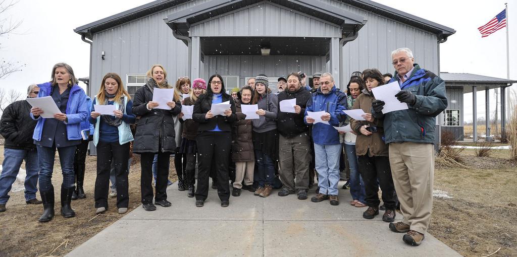 The group on March 18, standing outside the courtroom and reading the dismissal statement out loud. I am pictured in the middle, standing beside Martha Ferger, 90, the oldest Seneca Lake Defender.