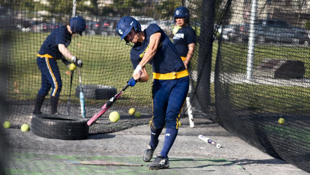 Freshman outfielder Emily Bloom swings at a pitch during batting practice April 13 at Kostrinsky Field. Bloom has led the Bombers to a 14–11 record this season and has played in 22 games this season in just her first year.