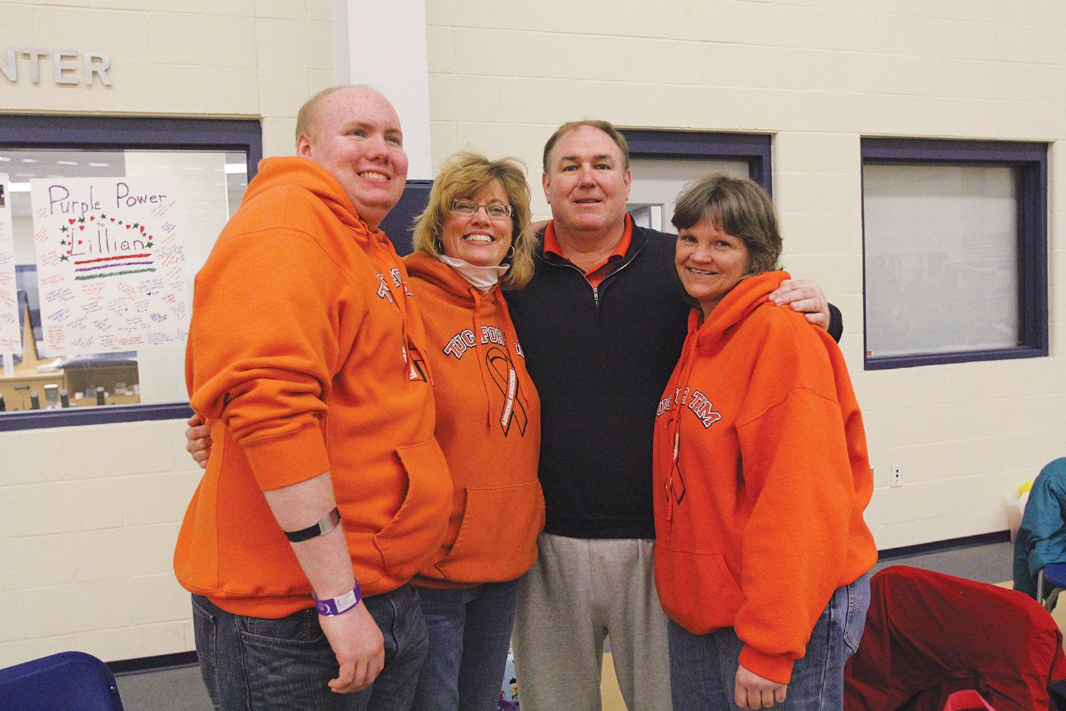 Catie Ihrig/ The Ithacan From left, Tim, Betsy Conners, Michael N. Conners and family friend Sue Darling attended the  college's Relay for Life on March 21, sporting orange sweatshirts that read "Tug for Tim."