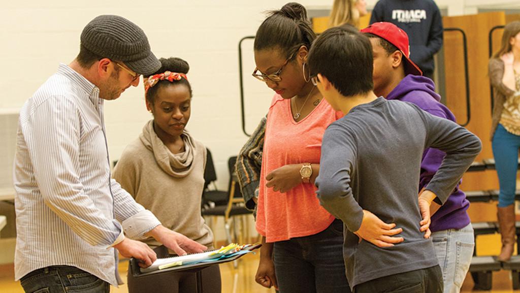 On left, Stage Director David Lefkowich works with students from the colleges opera workshop class to bring professor of music Dana Wilsons opera to life.