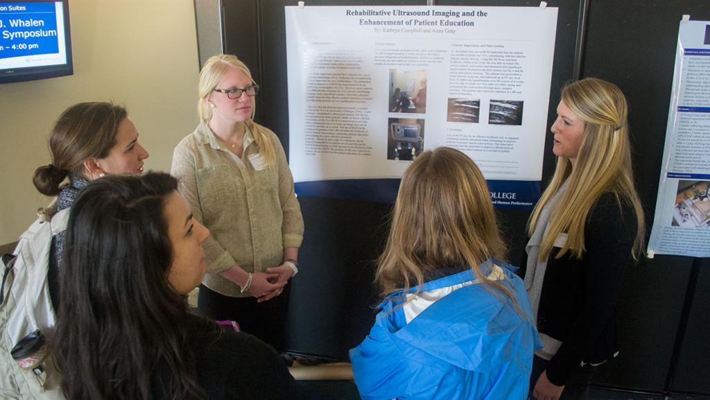 From left, junior Anna Gray and senior Kathryn Campbell, both majoring in physical therapy, present their research on ultrasound imaging and patient education at the Whalen Symposium April 14, 2014, in the North Foyer.