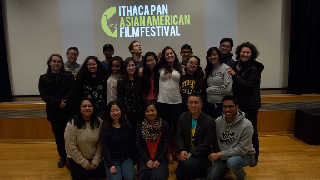 Members of the Asian American Alliance stand in front of the Pan Asian Film Festival logo April 1 in the Park Auditorium. 