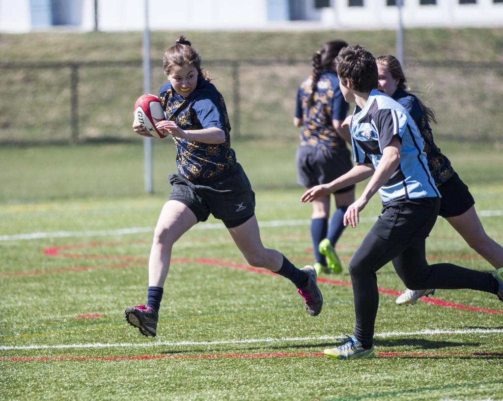 Senior Alexa Darwish attempts to dodge a tackle from a member of Ithaca's local women's rugby team, The Avengers. 