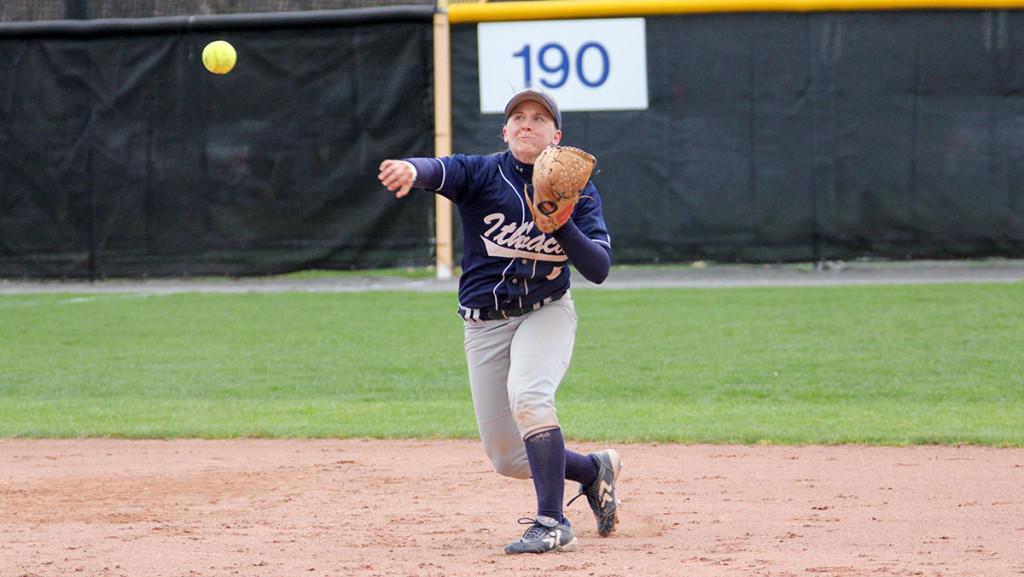 Senior captain Francesca Busa throws the ball toward first base to record an out during the  softball team’s 4–2 loss to Buffalo State College on April 26 at Kostrinsky Field in game two.