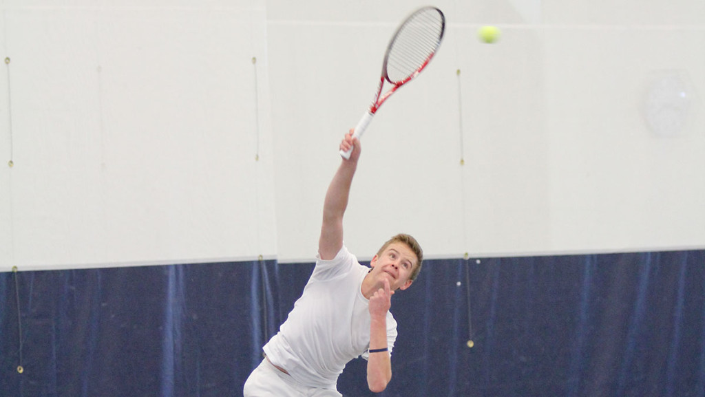 Freshman tennis player Jack Melhorn returns a serve in the men’s tennis team’s 9–0 victory over Alfred University on March 22. Melhorn has earned the Bombers’ No. 1 singles spot as a first year.	
