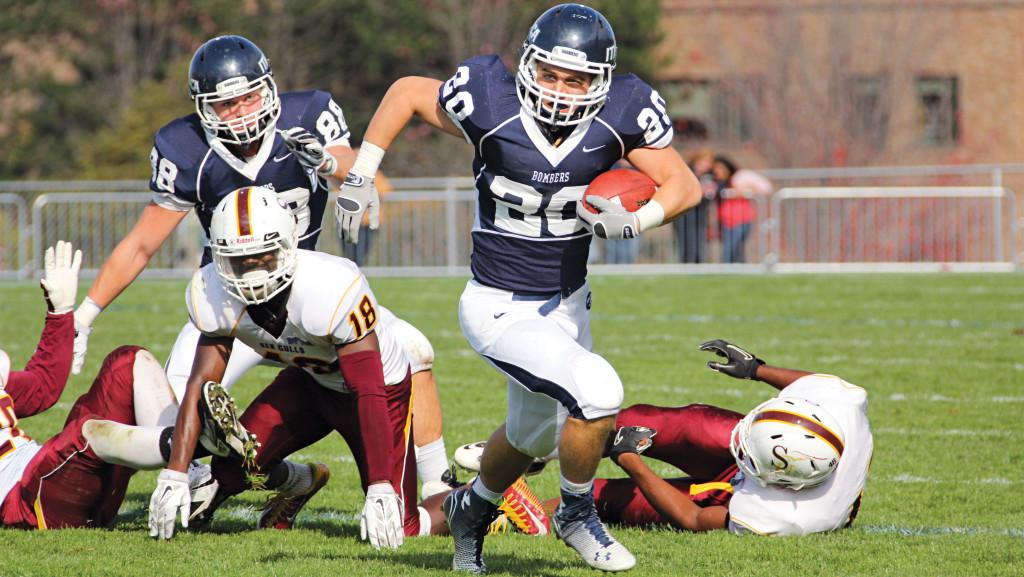 Senior John Iannone charges through the St. John Fisher College defense on Nov. 8, 2014, at Butterfield Stadium.