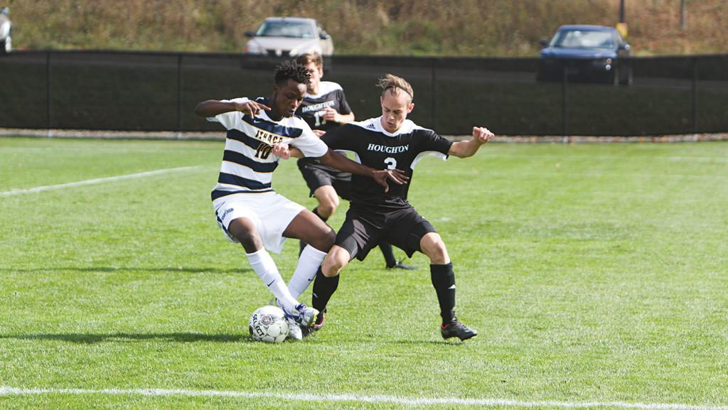 Junior midfielder Aziz Farouk attempts to cut right against a Houghton defender during a match Oct.  25, 2014, at Carp Wood Field. The South Hill squad seeks an Empire 8 title.