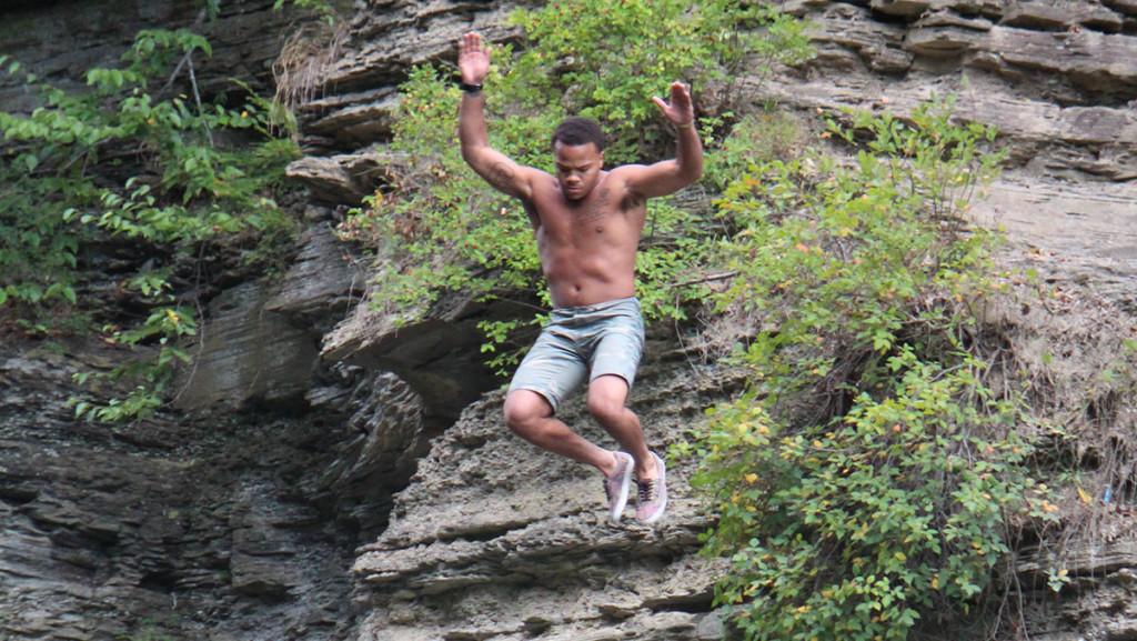 A man jumps from the cliffs into the water at Second Dam.